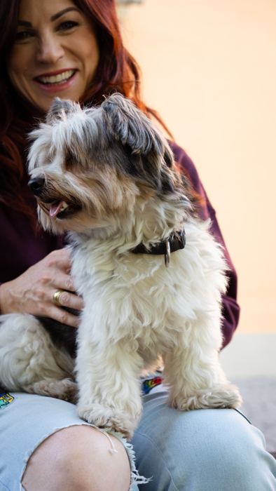 Nina Fleisch lacht mit ihrem Hund Rio auf dem Schoß